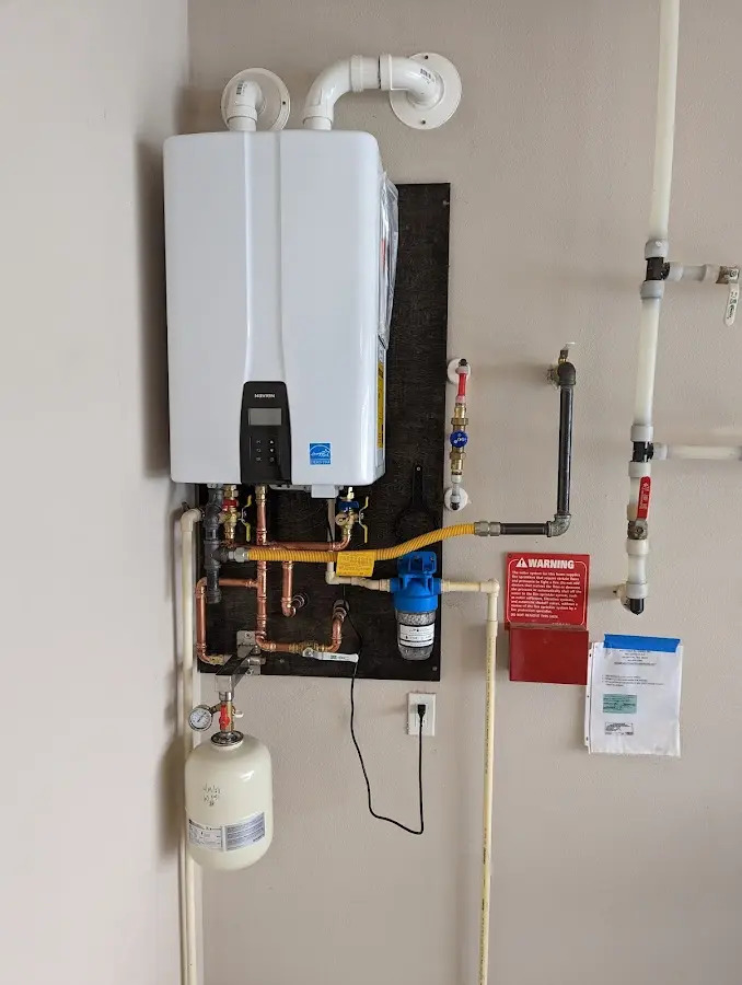 Professional plumber installing copper piping in a Mount Hermon home